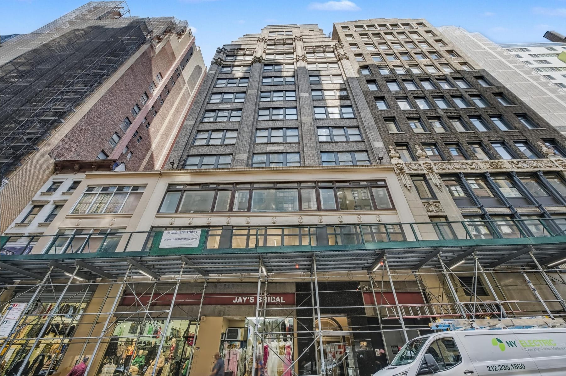 The facade as found - scaffolding and netting