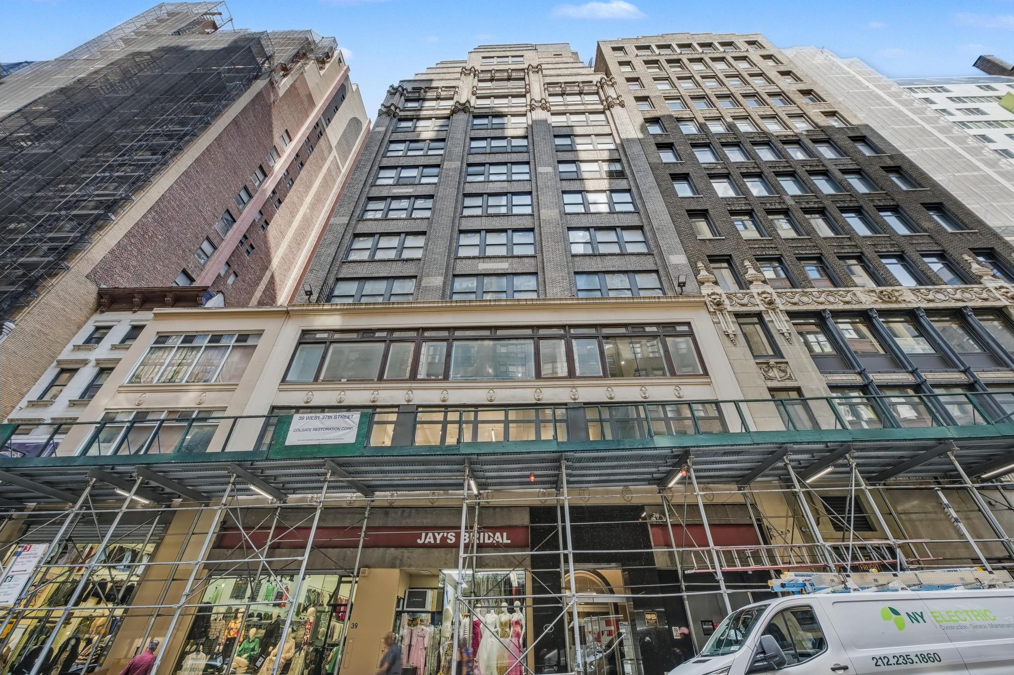 The facade as found - scaffolding and netting